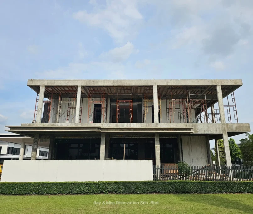 Front view of a bare concrete two-storey building under construction with exposed scaffolding —Project by Ray & Mist Renovation Sdn. Bhd.