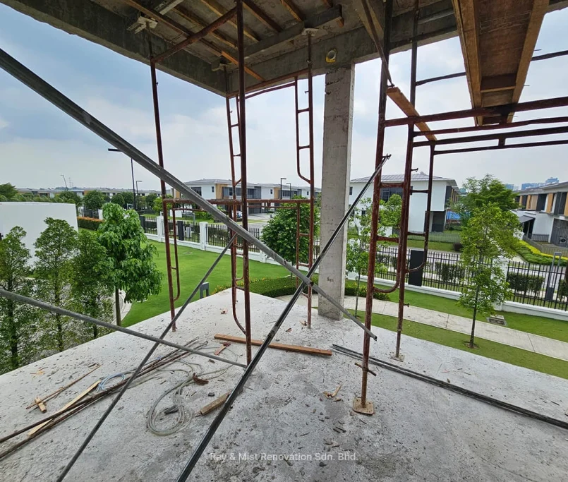 Concrete slab with exposed scaffolding poles overlooking a residential neighbourhood —Project by Ray & Mist Renovation Sdn. Bhd.