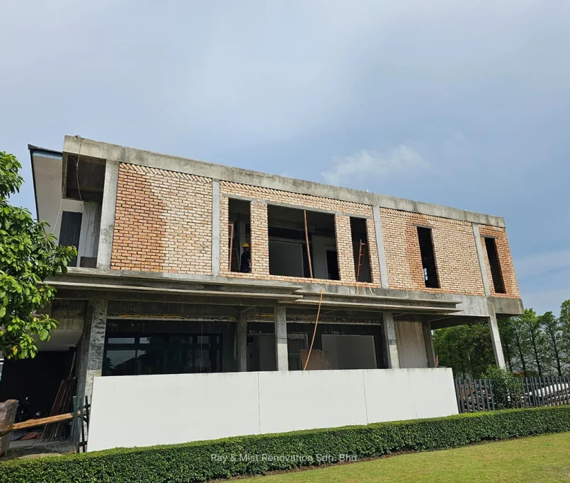 Front view of a double-storey building under construction with red brick walls —Project by Ray & Mist Renovation Sdn. Bhd.