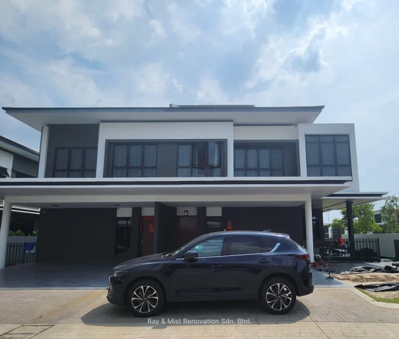 Front view of a completed two-storey modern home with dark trim and car porch —Project by Ray & Mist Renovation Sdn. Bhd.