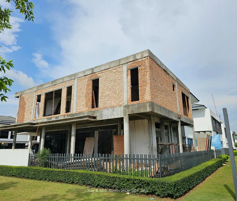 Corner angle of a two-storey red brick building under construction —Project by Ray & Mist Renovation Sdn. Bhd.
