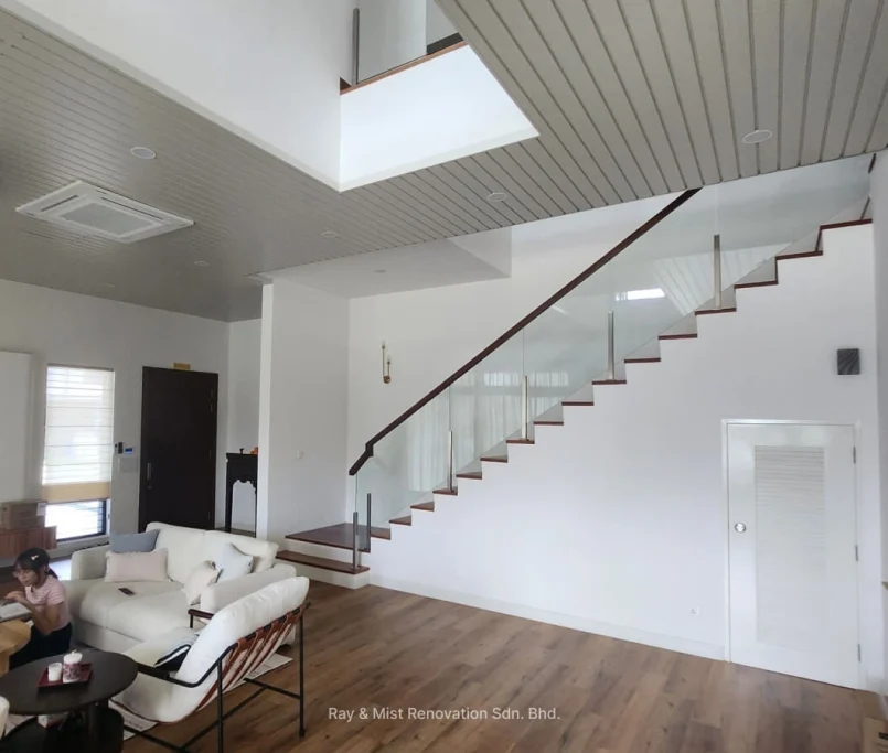 Spacious modern living room with floating staircase and wood-accented ceiling —Project by Ray & Mist Renovation Sdn. Bhd.
