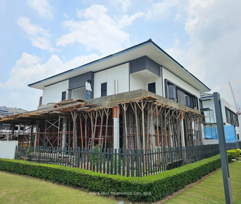Two-storey corner house under renovation with formwork and scaffolding surrounding the ground floor —Project by Ray & Mist Renovation Sdn. Bhd.