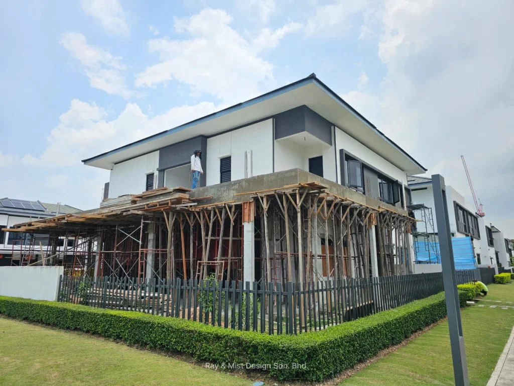 Two-storey corner house under renovation with formwork and scaffolding surrounding the ground floor —Project by Ray & Mist Renovation Sdn. Bhd.