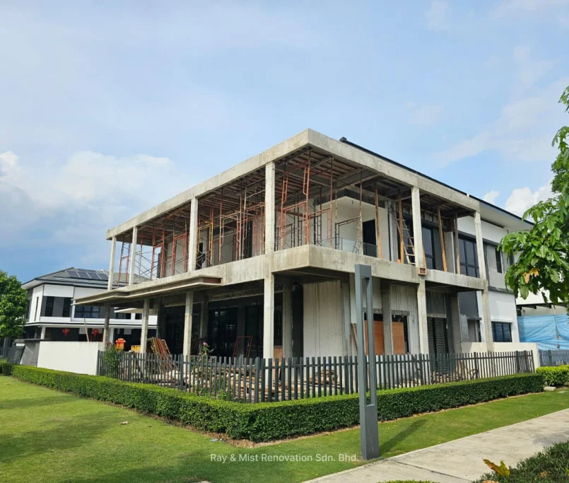 Corner angle of a two-storey house under construction with exposed concrete and scaffolding —Project by Ray & Mist Renovation Sdn. Bhd.
