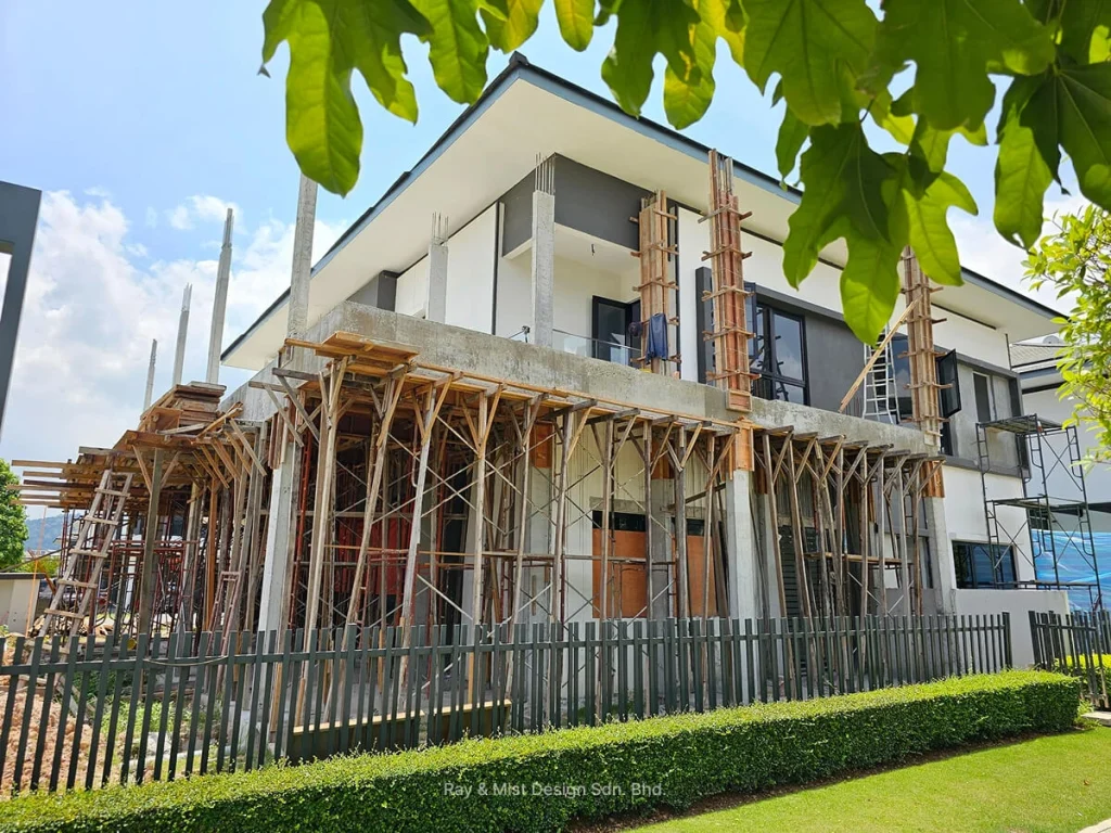 Angled view of house renovation with extensive scaffolding and formwork on concrete columns —Project by Ray & Mist Renovation Sdn. Bhd.
