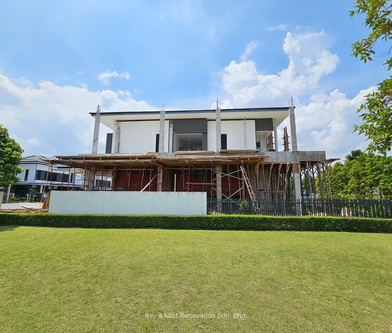 Frontal view of a two-storey house under construction with exposed concrete columns and timber scaffolding —Project by Ray & Mist Renovation Sdn. Bhd.