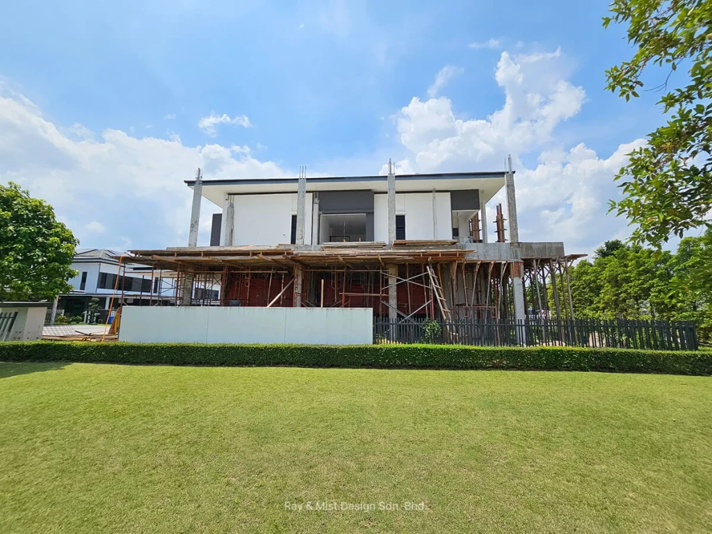 Frontal view of a two-storey house under construction with exposed concrete columns and timber scaffolding —Project by Ray & Mist Renovation Sdn. Bhd.