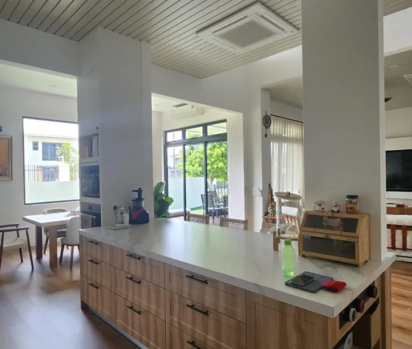 Modern kitchen island with wooden cabinetry and white countertop in open-plan space —Project by Ray & Mist Renovation Sdn. Bhd.