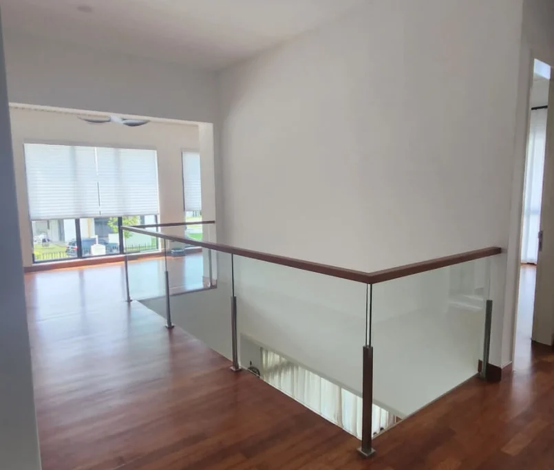 Upper floor hallway with glass railing and wooden flooring —Project by Ray & Mist Renovation Sdn. Bhd.