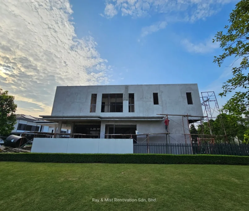 Front view of a two-storey house under renovation with scaffolding and evening sky —Project by Ray & Mist Renovation Sdn. Bhd.