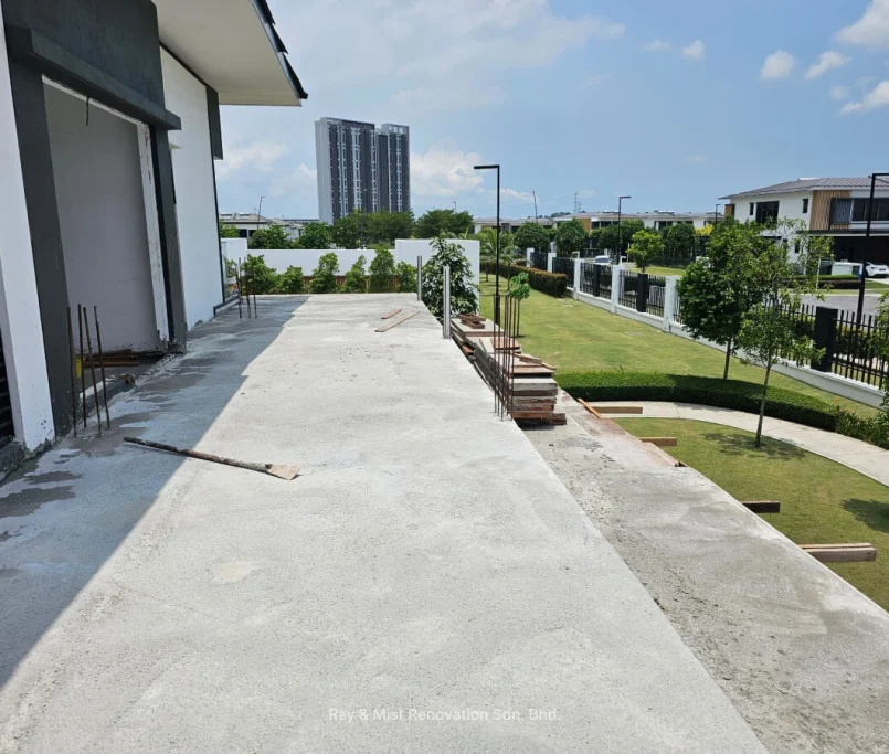 Newly constructed concrete extension at the back of a modern house overlooking a landscaped garden —Project by Ray & Mist Renovation Sdn. Bhd.