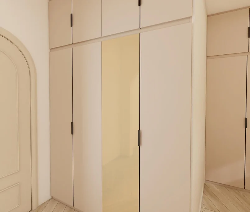 Full-height beige wardrobe with mirror panel and black handles —Project by Ray & Mist Design Sdn. Bhd.