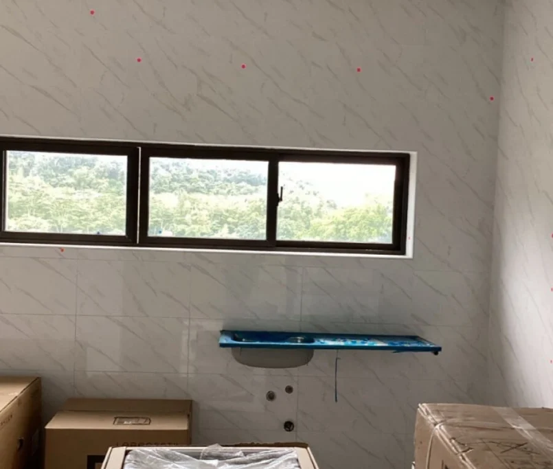 Unfinished kitchen with wall-mounted sink and appliance boxes on the floor —Project by Ray & Mist Design Sdn. Bhd.