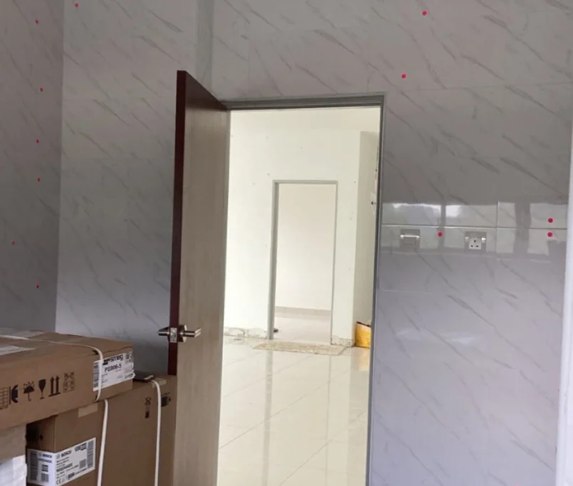 Doorway view of a tiled kitchen wall with appliance boxes —Project by Ray & Mist Design Sdn. Bhd.