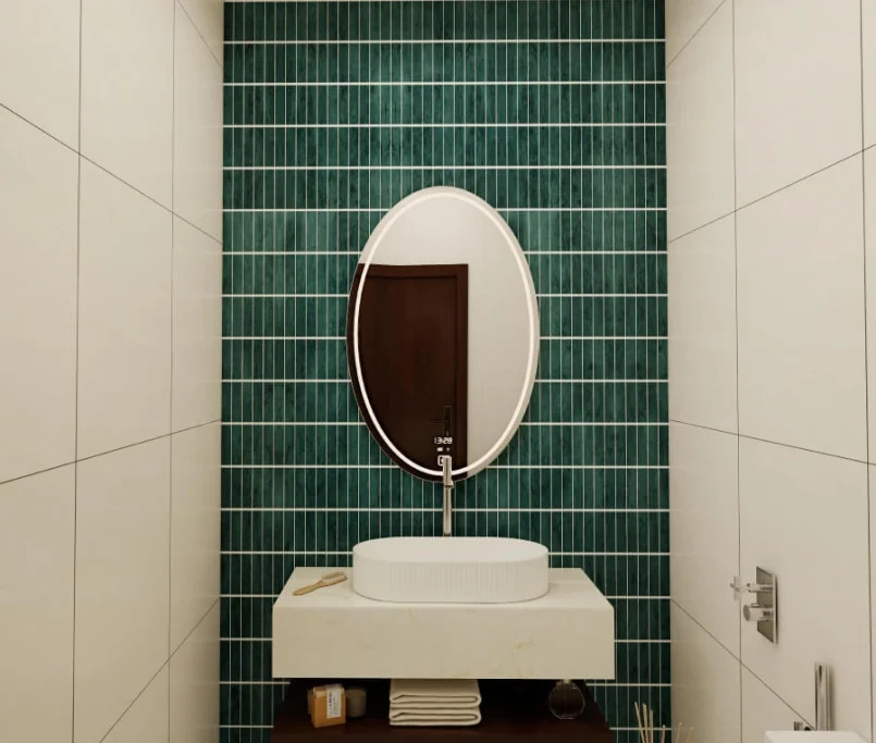 Modern bathroom with green feature wall tiles, oval mirror, and floating vanity — Project by Ray & Mist Renovation Sdn. Bhd.