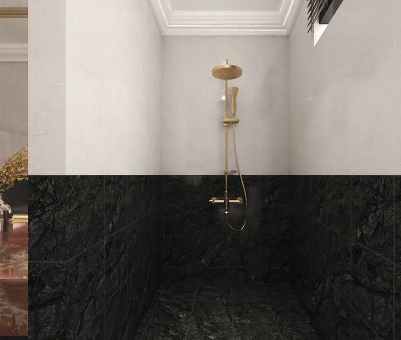 Walk-in shower with gold rainfall showerhead and dark green marble tiles.