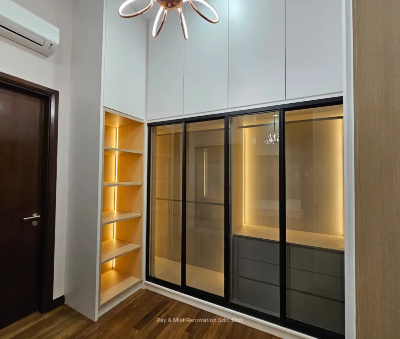 Custom wardrobe with glass sliding doors, open shelving, and ambient lighting —Project by Ray & Mist Design Sdn. Bhd.