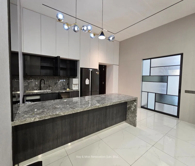 Modern kitchen with dark marble island, white overhead cabinets, and statement pendant lighting —Project by Ray & Mist Design Sdn. Bhd.