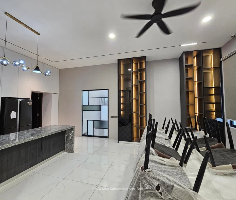 Open-concept dining and kitchen area with marble island, custom shelving, and pendant lighting —Project by Ray & Mist Design Sdn. Bhd.