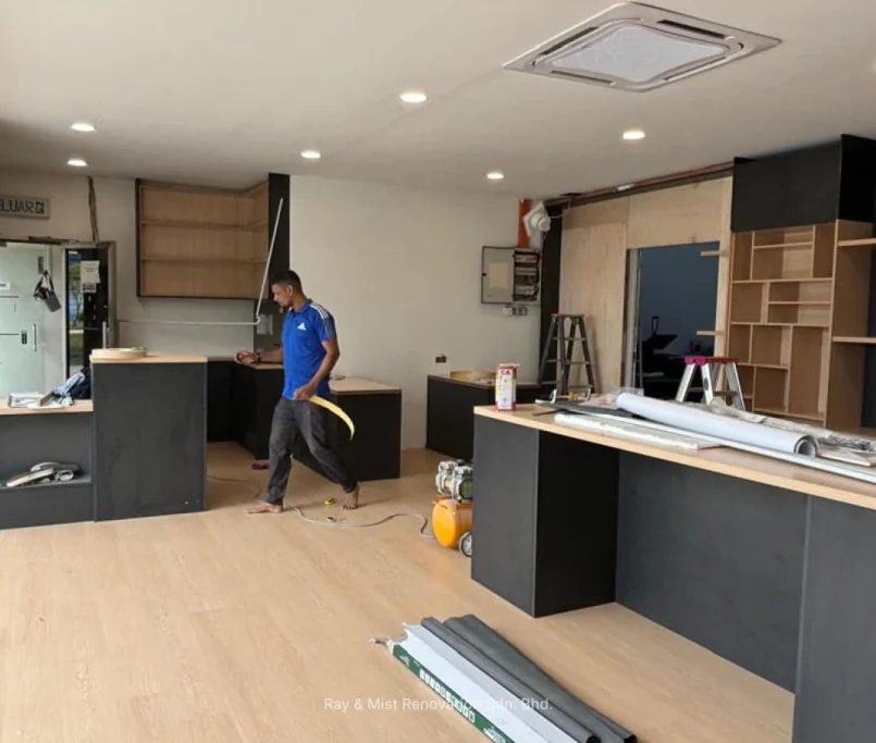Interior renovation in progress featuring black and wood cabinetry installation—Project by Ray & Mist Renovation Sdn. Bhd.