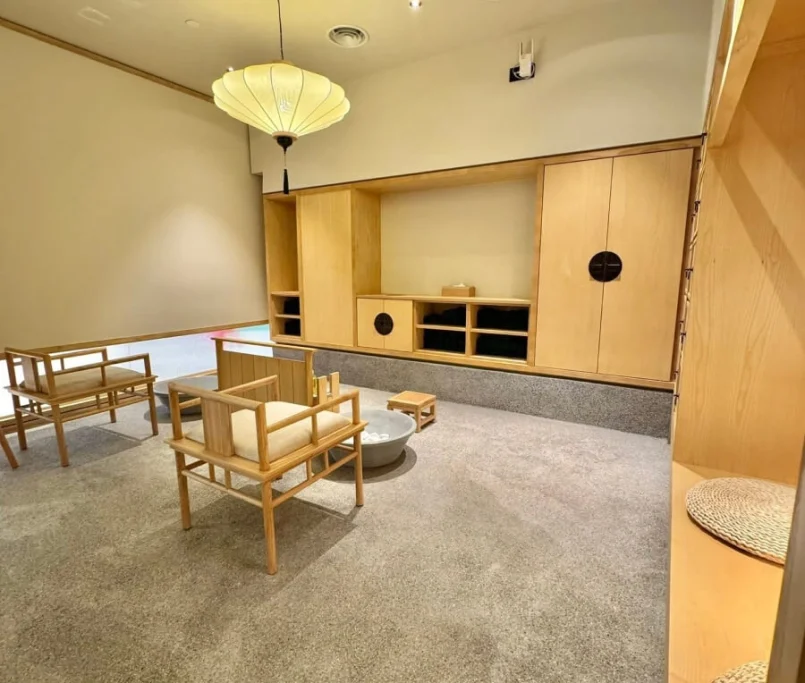 Minimalist Japanese-style sitting area with natural wood furniture, custom cabinetry, and a soft-lit lantern ceiling lamp —Project by Ray & Mist Design Sdn. Bhd.