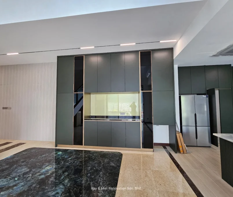 Tall matte green kitchen cabinet with integrated oven and yellow glass backsplash — Project by Ray & Mist Renovation Sdn. Bhd.