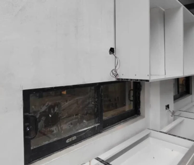 White kitchen cabinets under installation with visible wiring and unfinished wall surface — Project by Ray & Mist Renovation Sdn. Bhd.