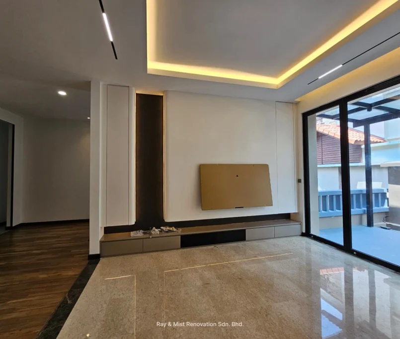 Modern living room with recessed ceiling lights, built-in TV panel, and sliding glass doors — Project by Ray & Mist Renovation Sdn. Bhd.