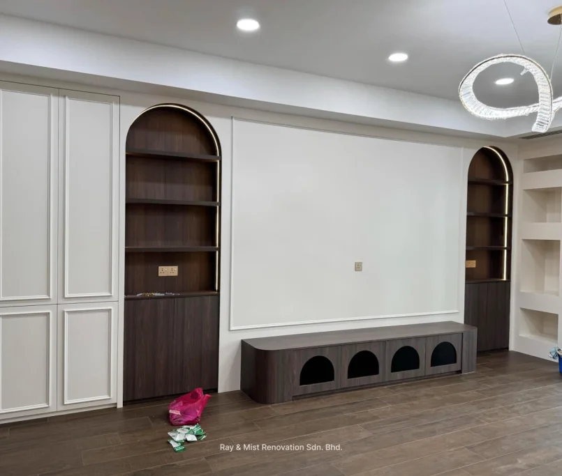 Living room feature wall with arched bookshelves, classic panel cabinets, and pet cubby bench — Project by Ray & Mist Renovation Sdn. Bhd.
