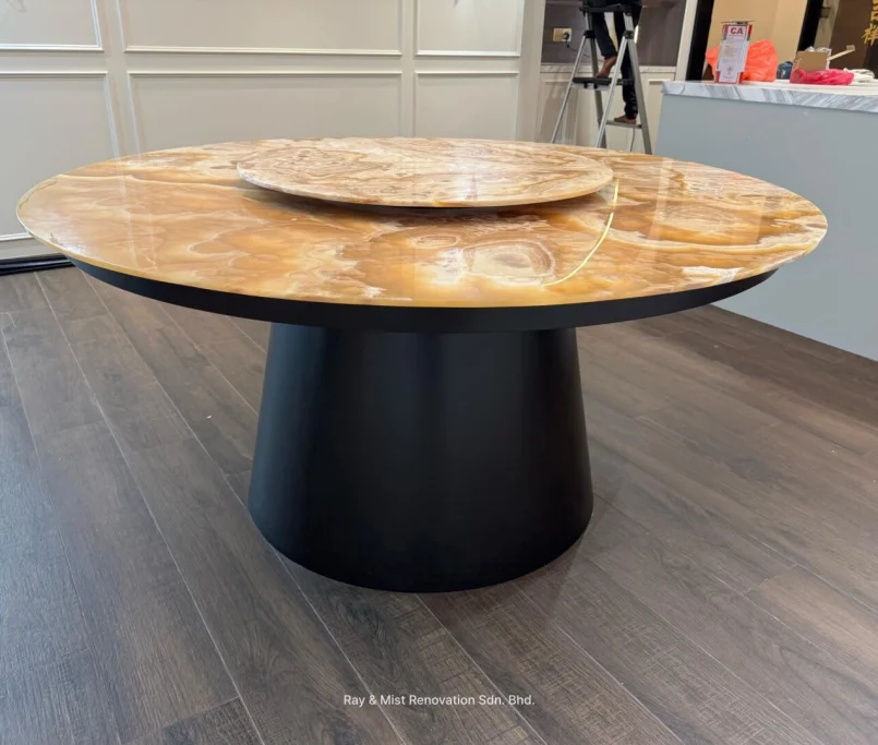 Round onyx dining table with a black cylindrical base and matching Lazy Susan — Project by Ray & Mist Renovation Sdn. Bhd.