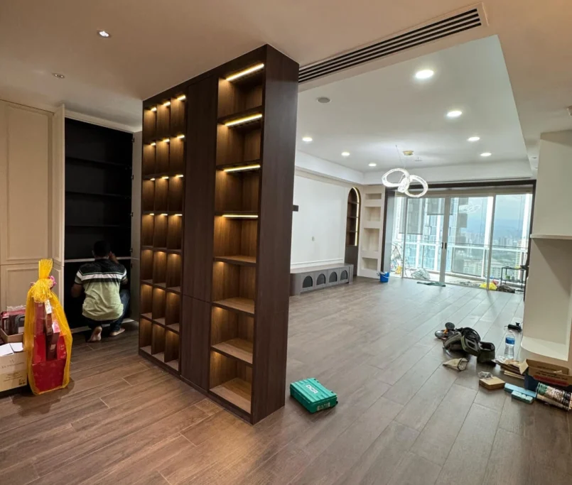 Partition bookshelf with integrated lighting dividing a modern living space — Project by Ray & Mist Renovation Sdn. Bhd.