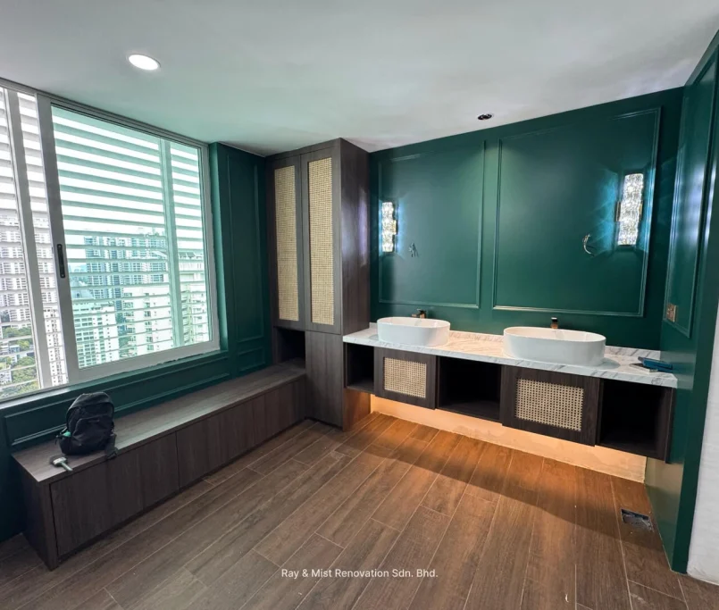 Double vanity sink setup against a green accent wall with under-cabinet lighting and a city view — Project by Ray & Mist Renovation Sdn. Bhd.