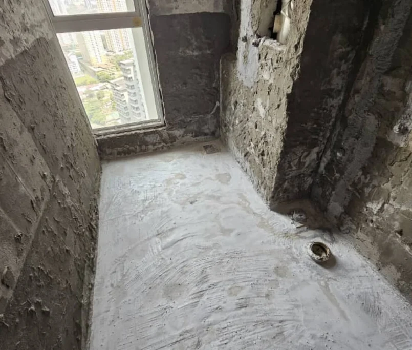 Bathroom under renovation with exposed concrete walls and plumbing pipe opening near a tall window — Project by Ray & Mist Renovation Sdn. Bhd.